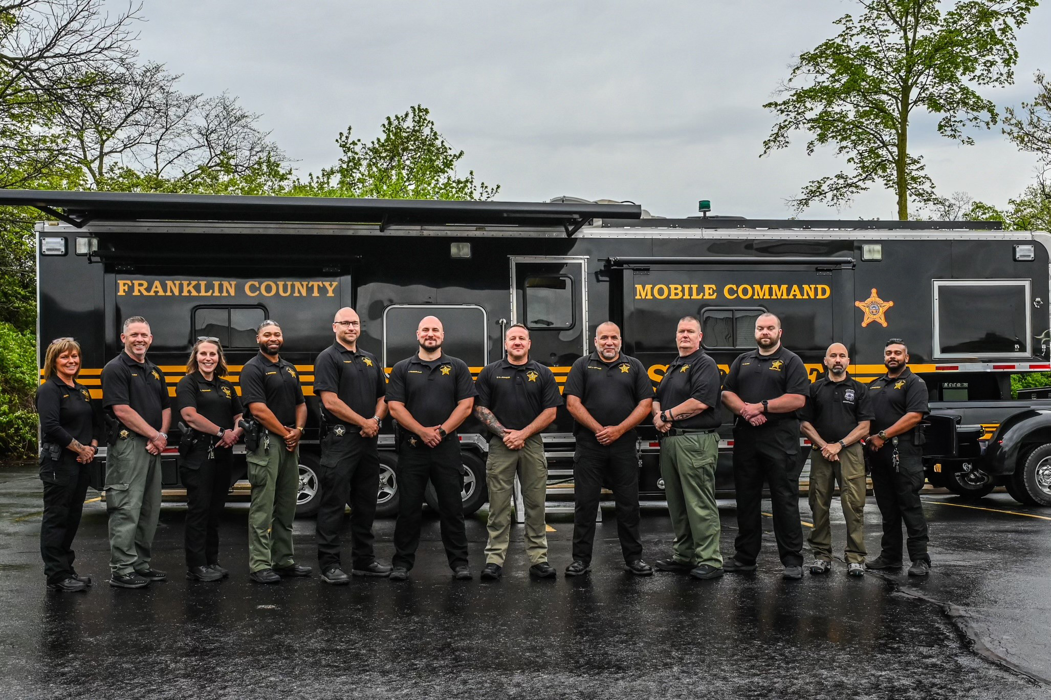 deputies standing in front of vehicle